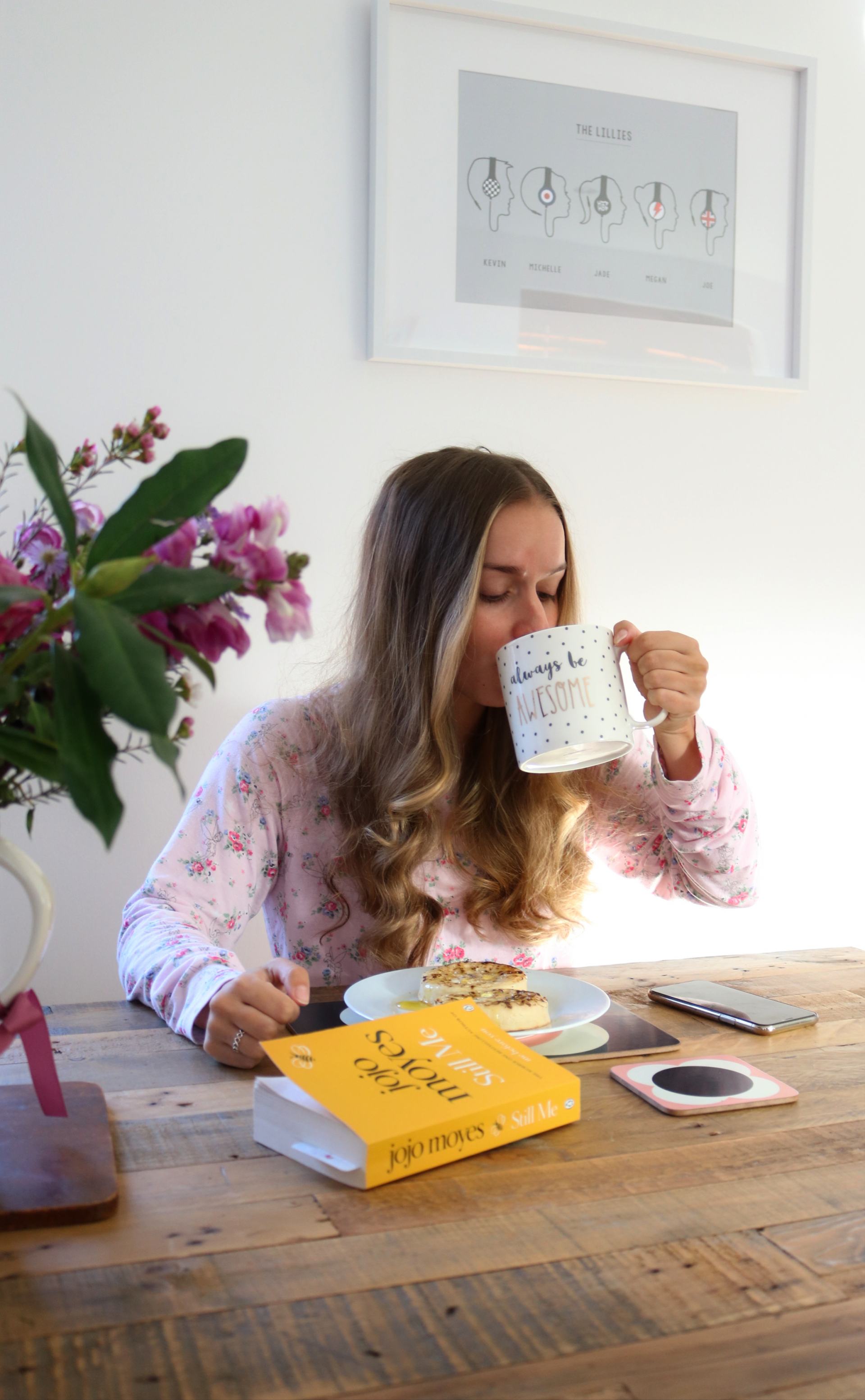 girl sat at table drinking a cup of tea - 4-day working week